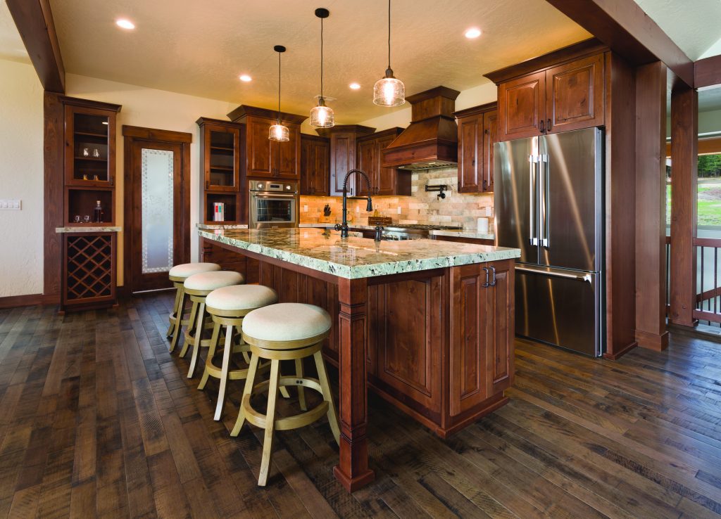 A kitchen with hardwood floors and a center island.