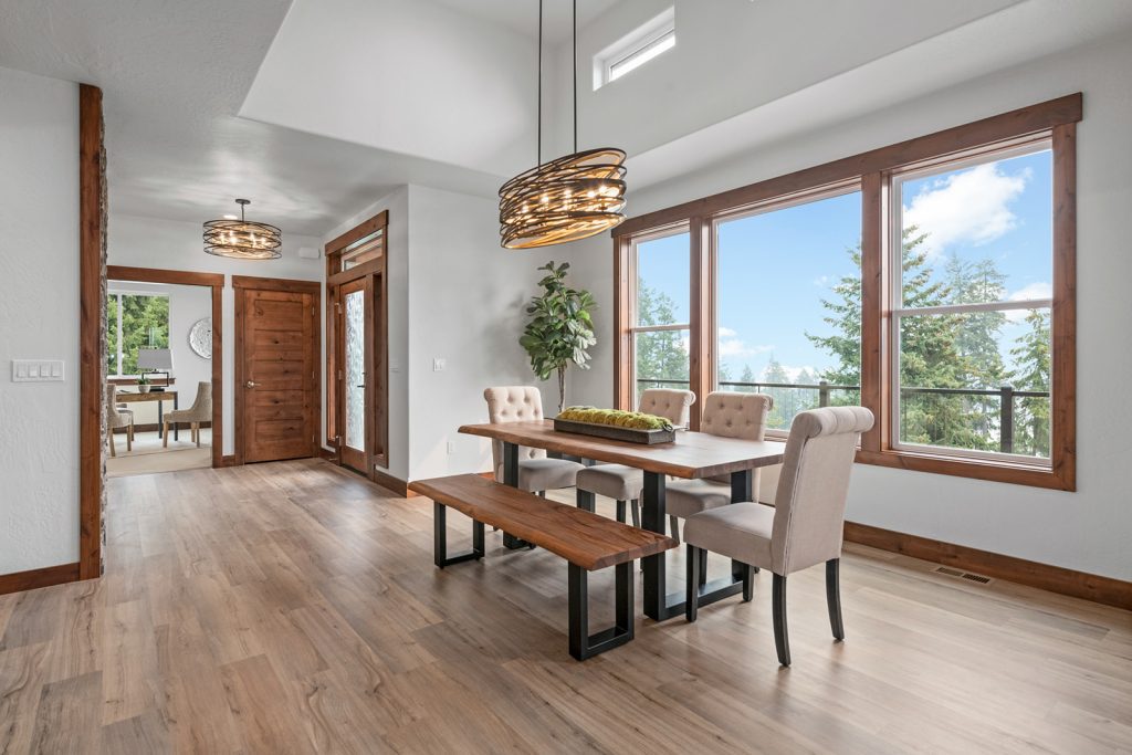 A dining room with hardwood floors and a view of the mountains.