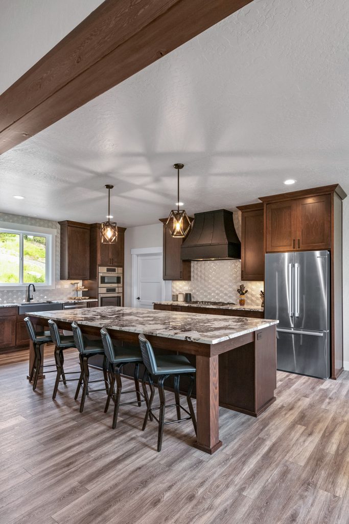 A large kitchen with wood floors and a center island.