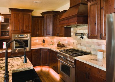 A kitchen with wooden cabinets.